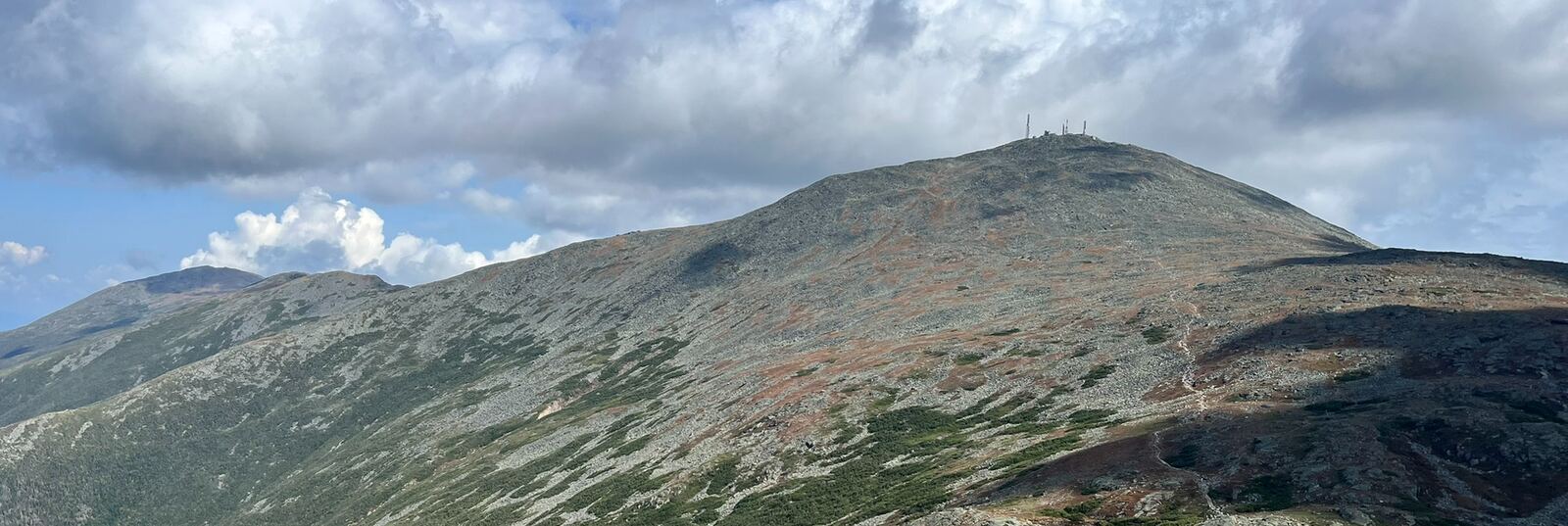 Mount Washington's summit, with its buildings and towers, above the rocky alpine slopes of the Presidential Range